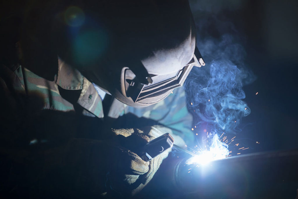 helmeted worker welding